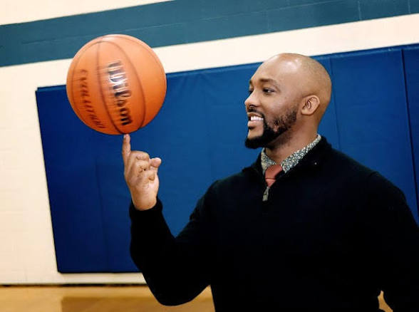 Kingdom Abound founder spinning a basketball on his fingertip inside the home gym (2024)