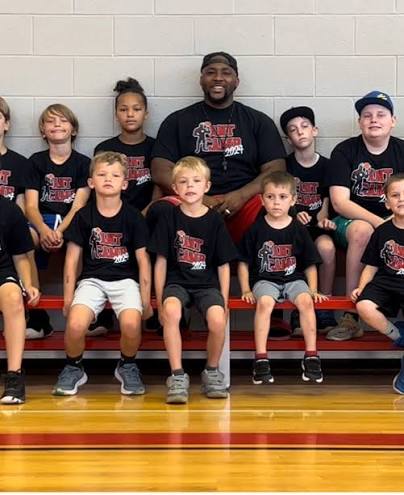 Kingdom Abound youth campers posing with their coach at the 2024 Mighty Ants Skills Camp
